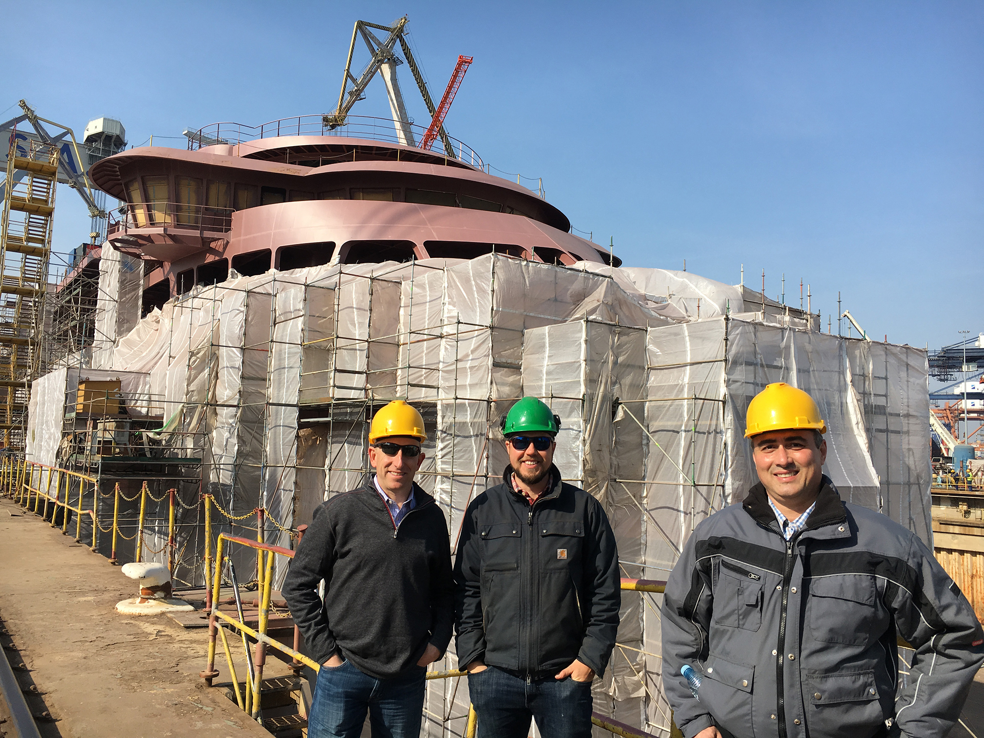 The Lindblad team on site at the hull yard, from left CFO Craig Felenstein, site manager Reed Ameel and senior vice president newbuilding, Nikos Doulis. Reed and Nikos will also be site representatives at Ulstein Verft.