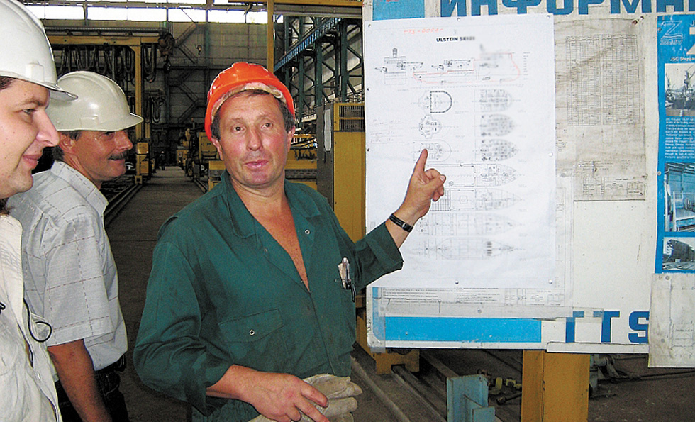 A Zaliv employee with drawings of the first hull of an ULSTEIN X-BOW® vessel to be built at the yard. 